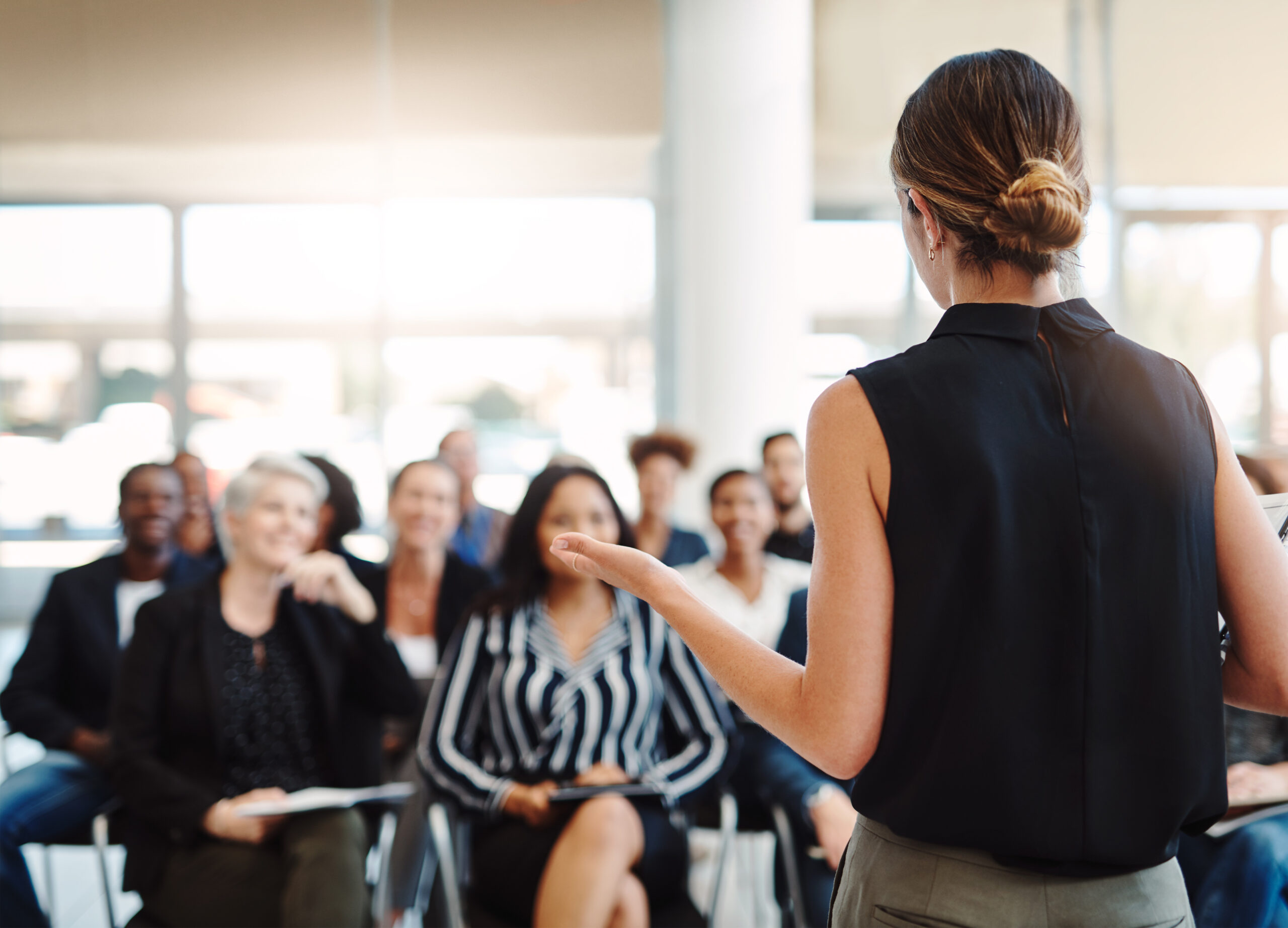 Photo of a young businesswoman delivering a speech during a conference